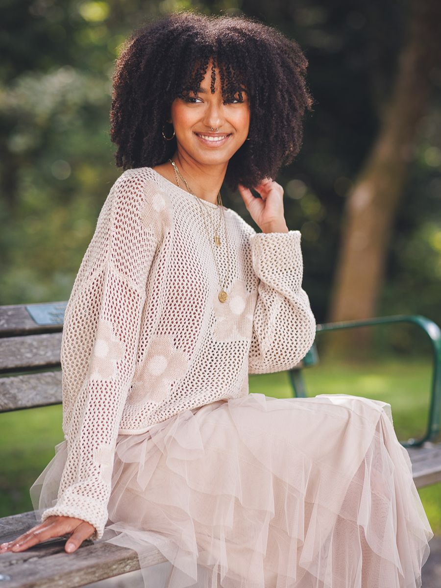 Cream open-knit floral sweater styled with layered tulle skirt, featuring Papillon Daisy Net Crew Sweater by Papillon brand.