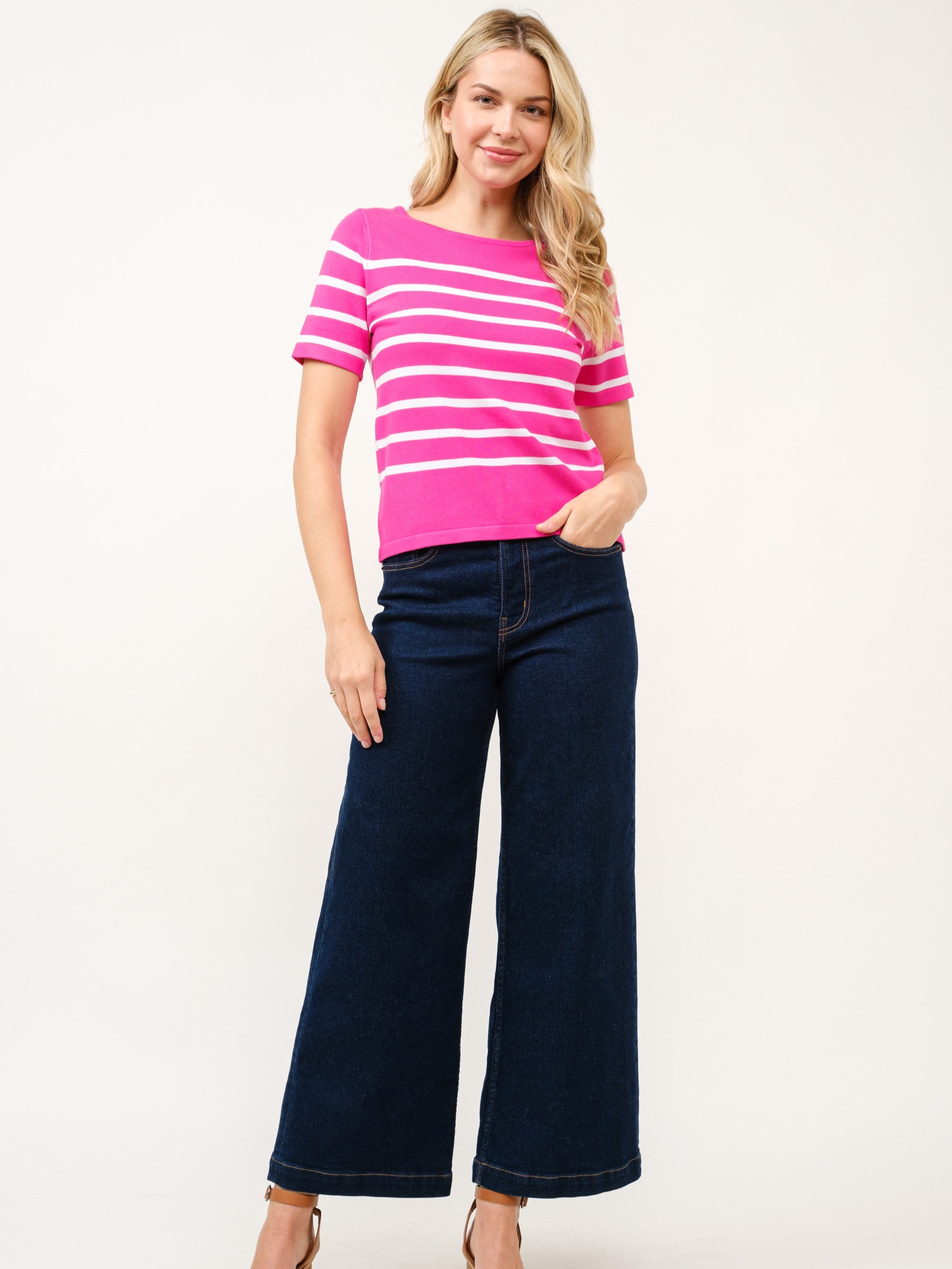 Cielo Striped Short Sleeve Crew Neck Sweater in bright pink and white stripes by Cielo 1985 Inc. paired with dark denim pants