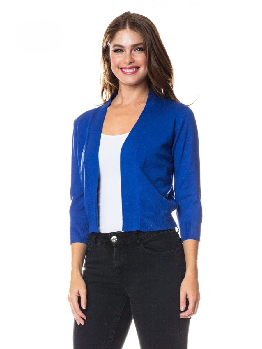 Blue open-front Cielo Bolero Open Cardigan sweater by Cielo 1985 Inc., styled with white top and black jeans.