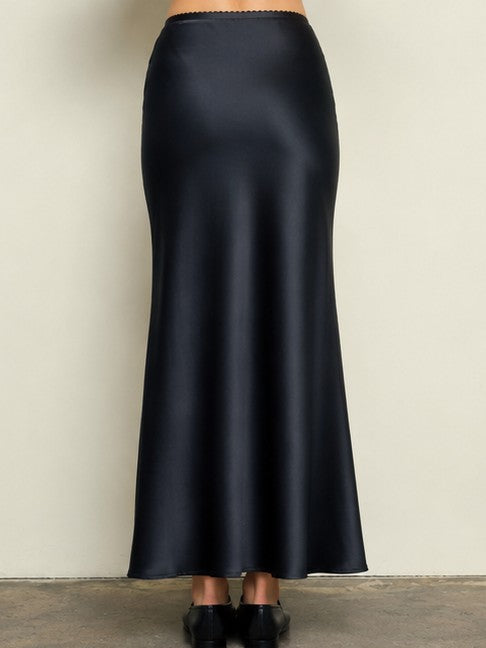 Black satin maxi skirt displayed on a mannequin against a neutral background