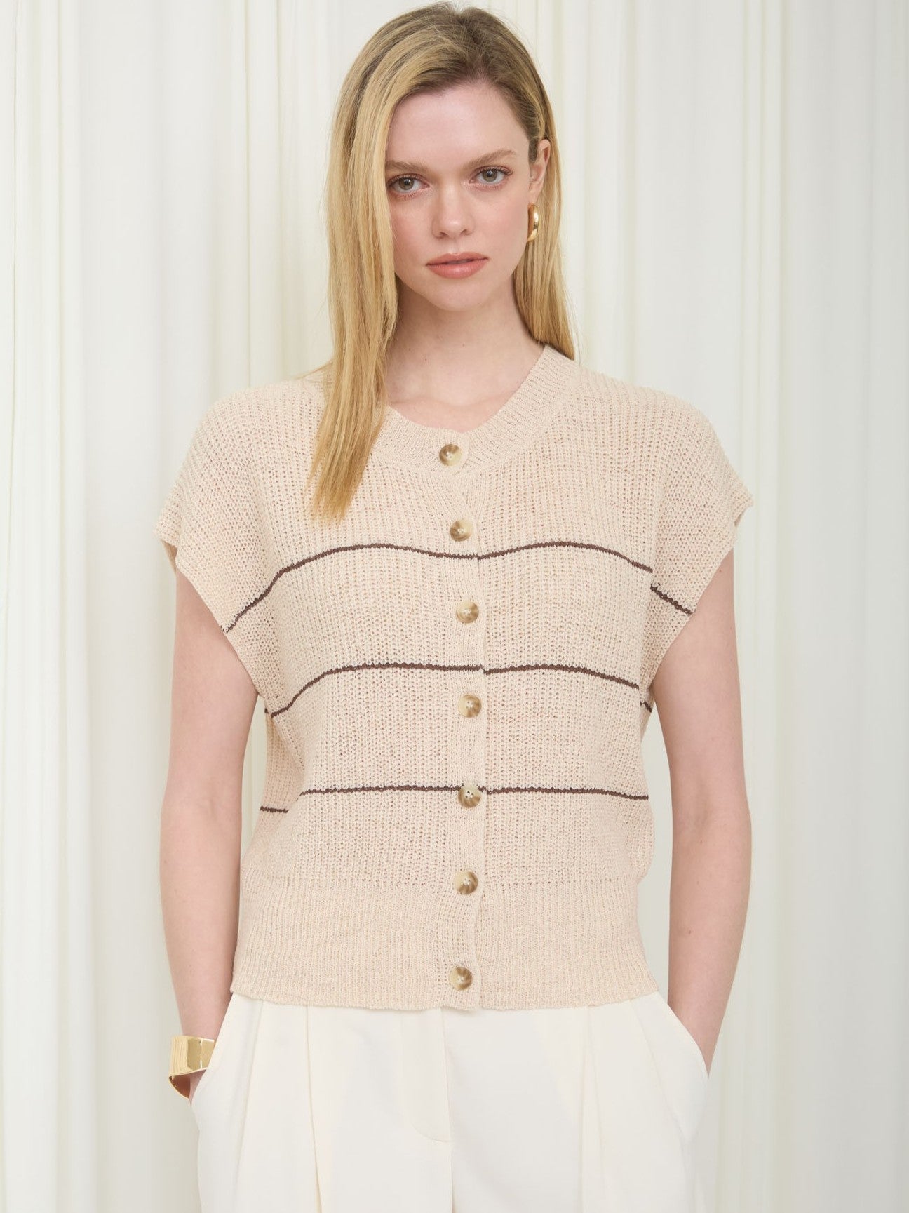 Striped Button-Front Short Sleeve Cardigan by Mine in beige with dark stripes, button details, styled with white pants.