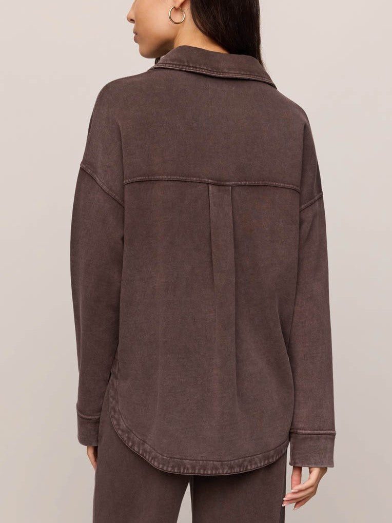 Back view of a brown long-sleeve jacket with a collar and back pleat detail.