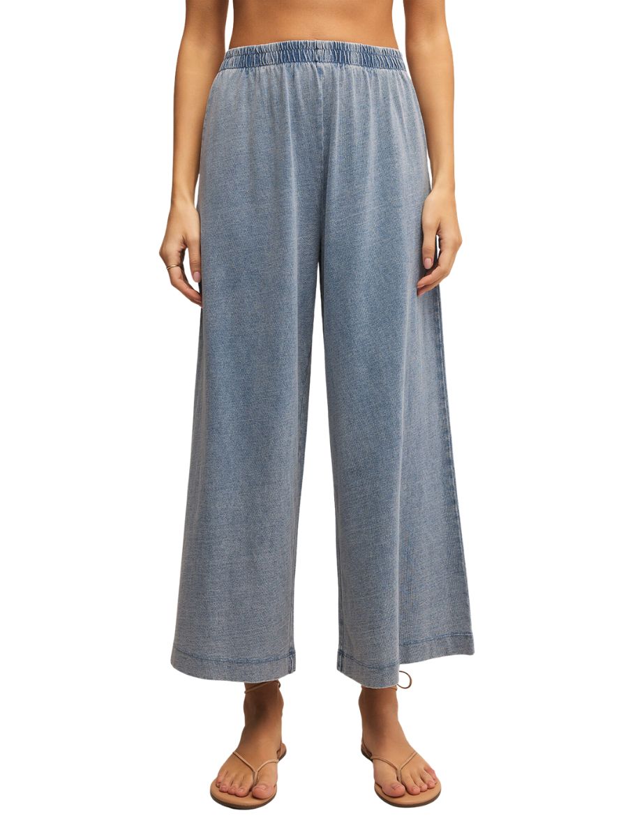 Z Supply Scout Jersey Denim Pant in light blue with wide legs and elastic waistband, styled with simple sandals
