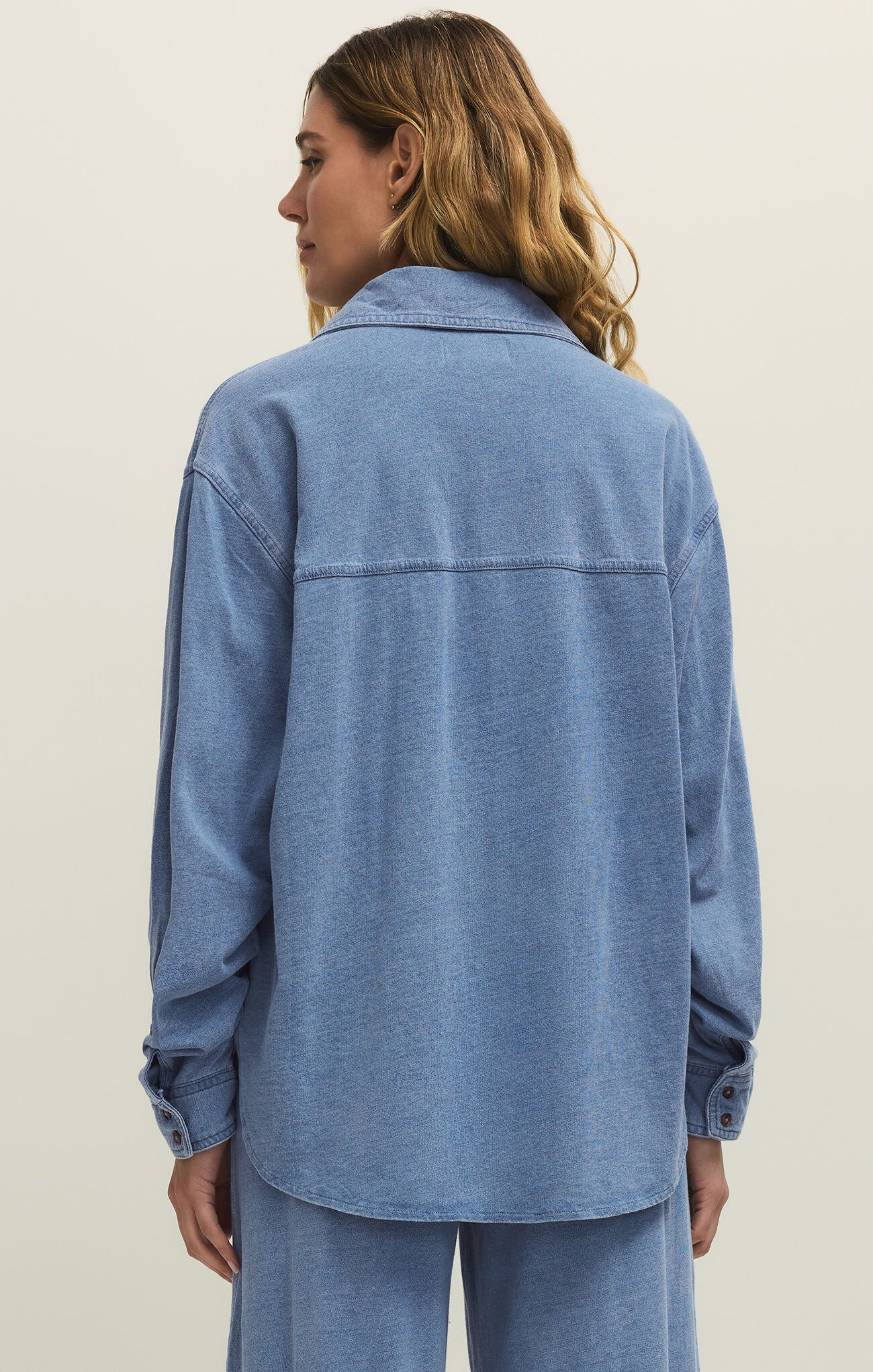 Back view of Z Supply Reese Long Sleeve Jersey Button Up in soft blue knit, styled with matching bottoms
