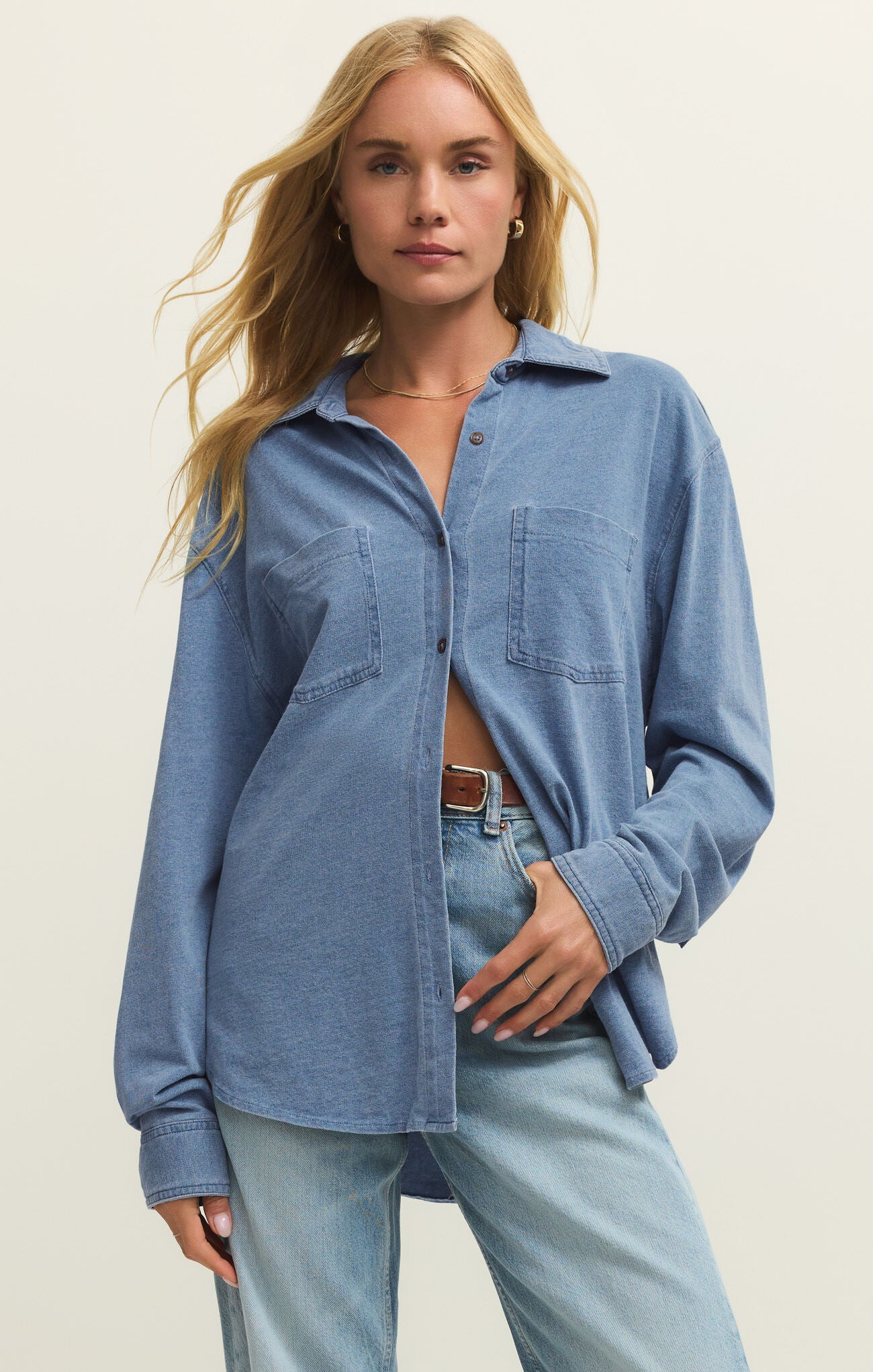 Z Supply Reese Long Sleeve Jersey Button Up in denim blue paired with light wash jeans for casual outerwear style